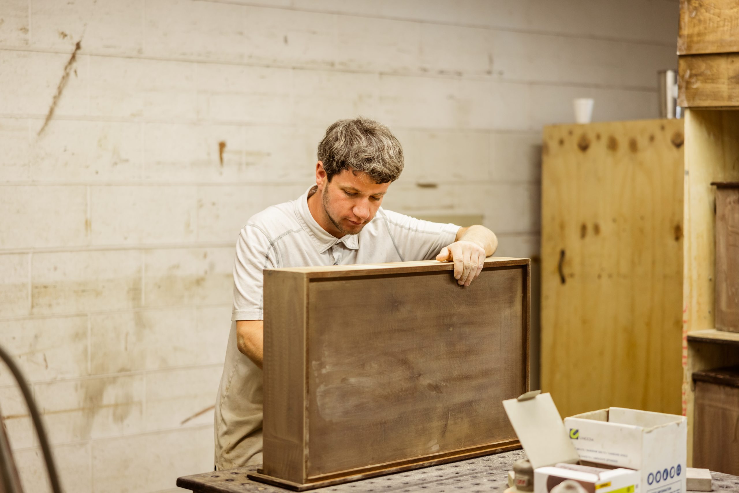Amish craftsman working on a drawer