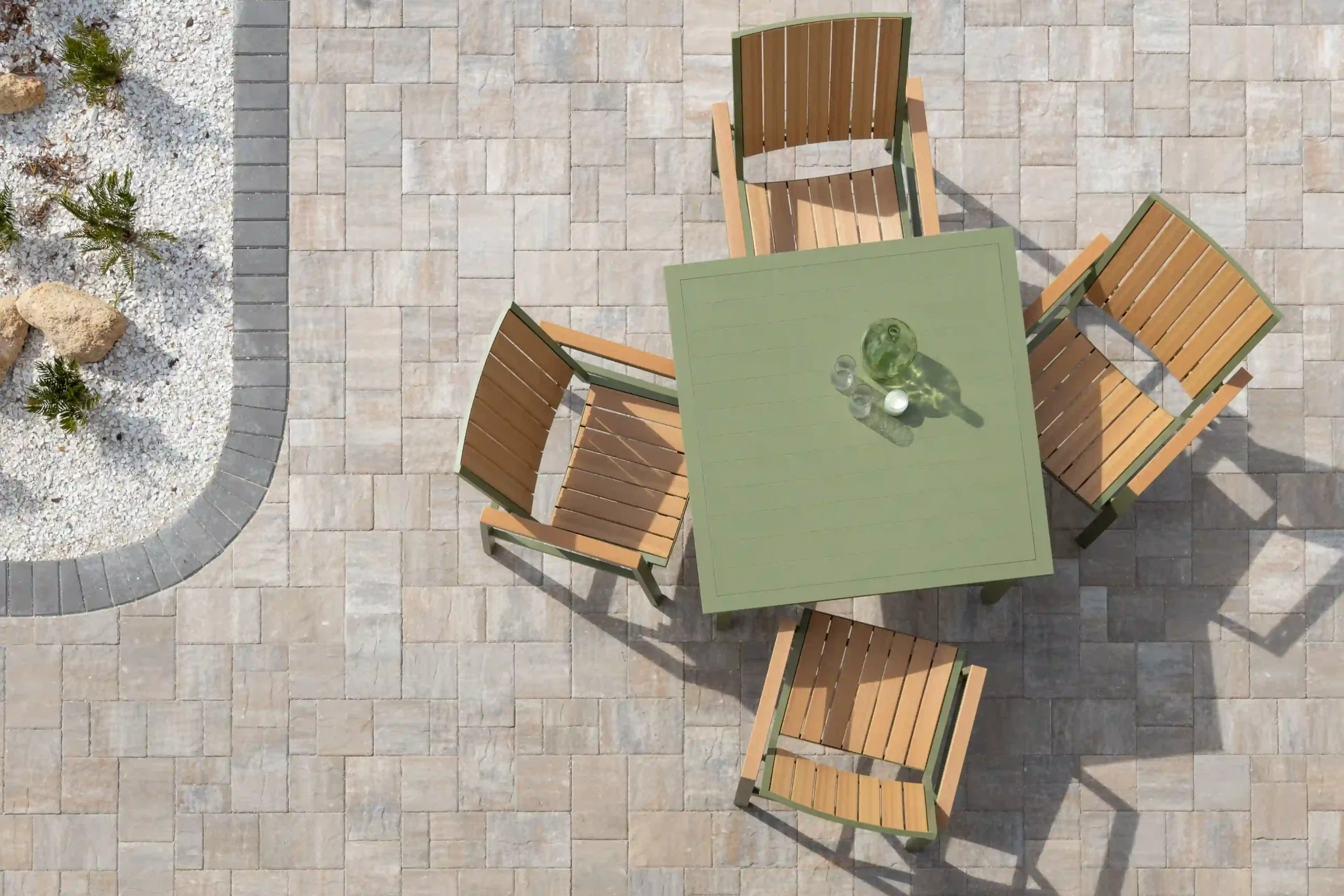 Aerial view of Vida Collection outdoor poly lumber dining set with sage green square table and four two-tone chairs featuring wood-grain brown seats with sage green frames on beige paver patio