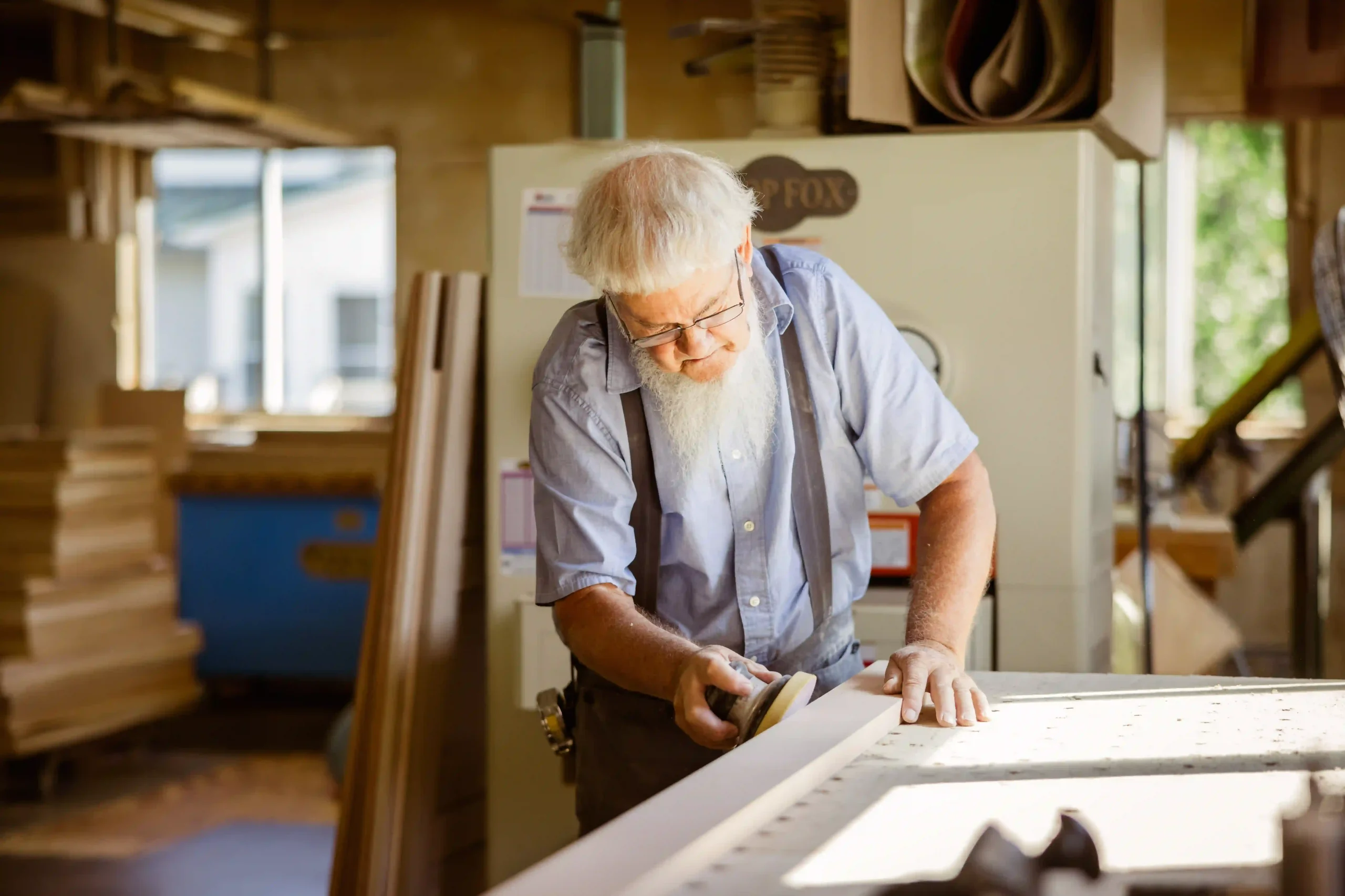 Amish craftsman hand-finishing furniture in an Orrville, Ohio workshop