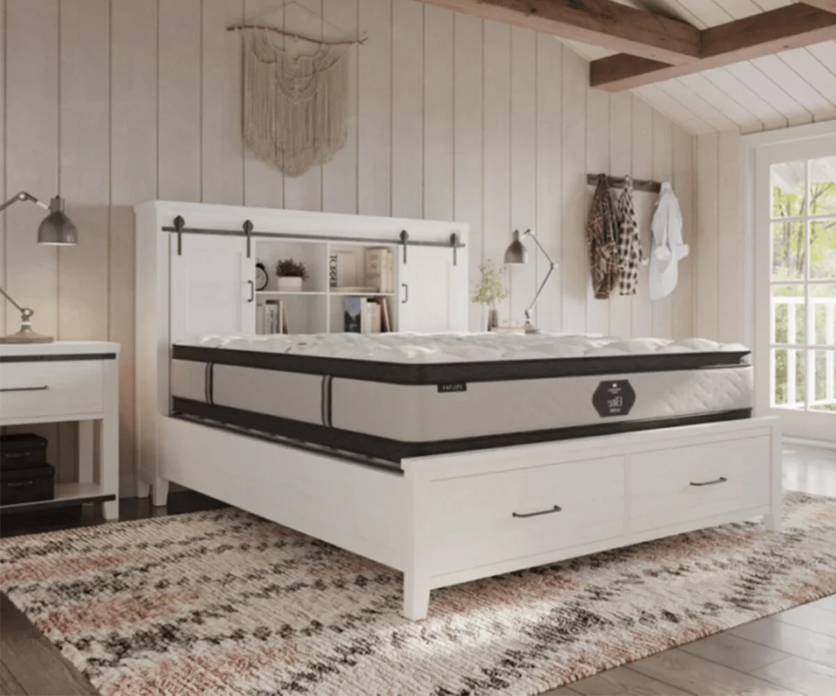 Amish Elite collection mattress with a dark border on a white storage bed in a farmhouse-style bedroom.