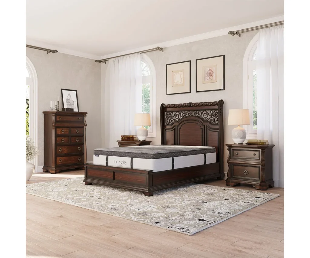 Amish Integrity collection mattress on an ornately carved dark wood bed in a traditional bedroom setting.
