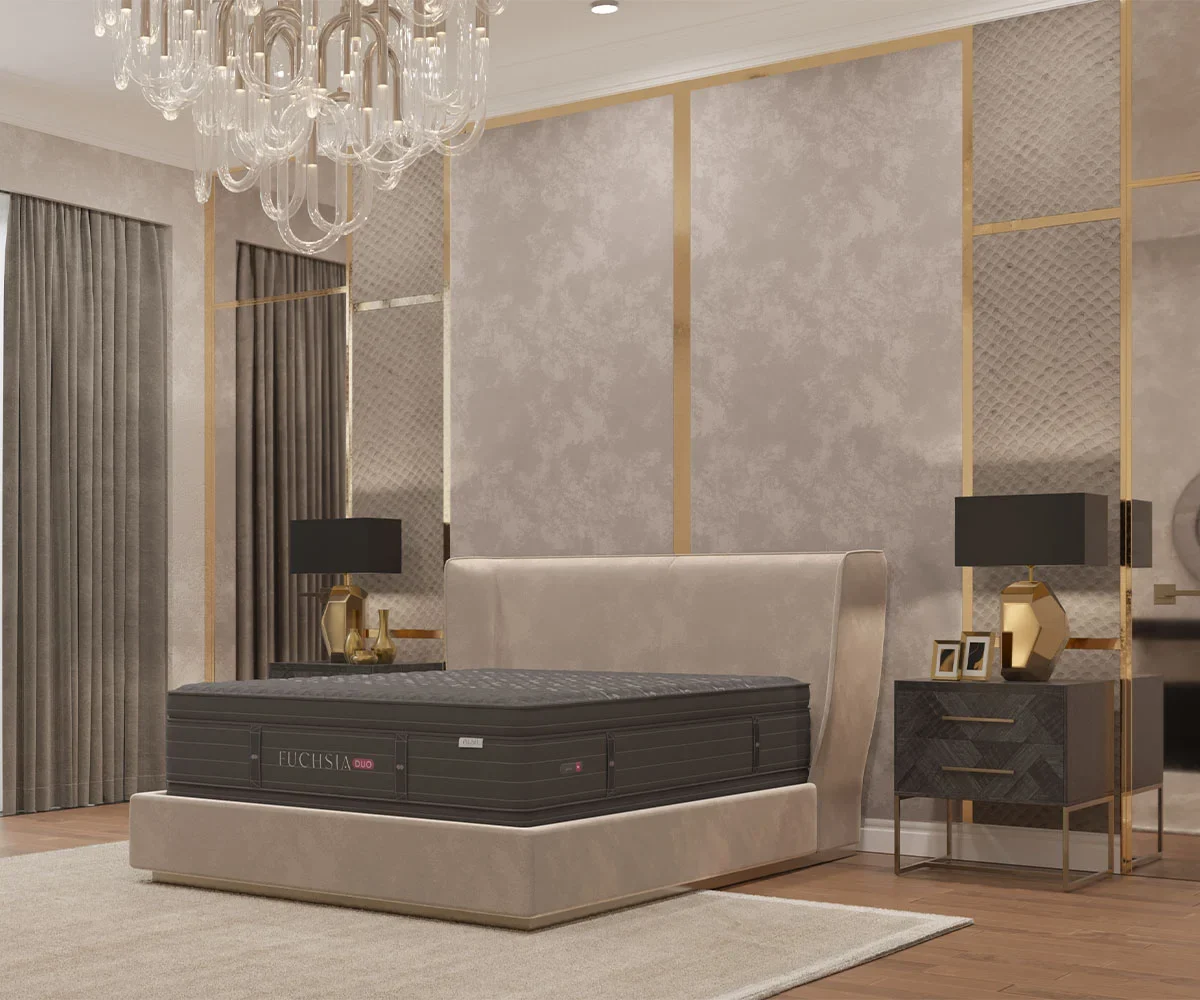 Amish Fuchsia collection mattress with a dark quilted top and border, staged low in an elegant gold-accented bedroom.