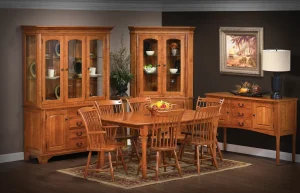 Amish Concord dining collection staged in a warm-toned room with an oak table, Windsor chairs, hutch, and buffet.