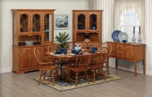 Amish Heritage dining collection shown in a bright room with an oak table, Windsor chairs, a hutch, and a corner hutch.