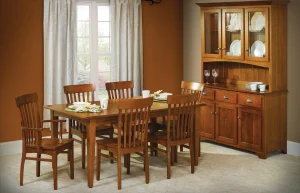Amish Mary Ann dining collection in oak, staged in a warm room with a mission table, chairs, hutch, and buffet.