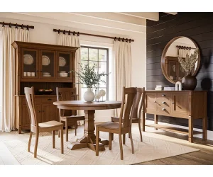 Amish Ashville dining collection in light oak, staged with a round pedestal table, chairs, hutch, and sideboard.