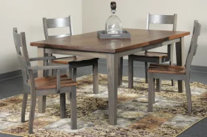 Amish Barnwood dining collection in reclaimed two-tone wood, staged with a table and chairs on a patterned rug.